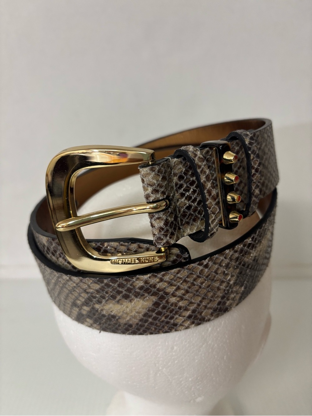 Michael Kors snake print leather belt features a polished gold-tone buckle
